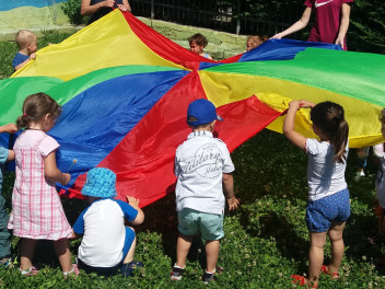 Bambini con un paracadute colorato